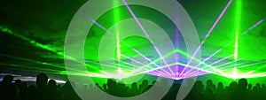 Lasershow festival disco  party background banner panorama - Colorful outdoor laser show with rays streams and crowd silhouette of