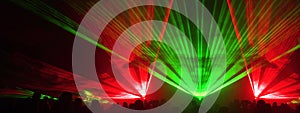 Lasershow festival disco  party background banner panorama - Colorful outdoor laser show with rays streams and crowd silhouette of