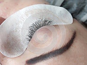 Lash extensions in beauty salon macro eye top view