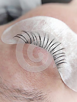 Lash extensions in beauty salon macro eye top view