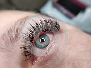 Lash extensions in beauty salon macro eye top view