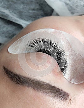 Lash extensions in beauty salon macro eye top view