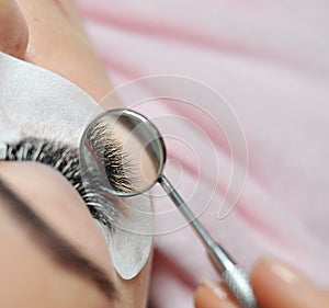 Lash extensions in beauty salon macro eye top view