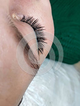 Lash extensions in beauty salon macro eye top view