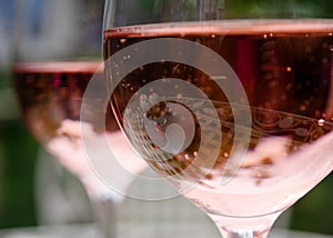 lasses of champagne on wooden table in the garden