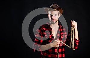 Lasso tool of American cowboy. Still used on ranches to capture cattle or other livestock. Western life. Man unshaven photo