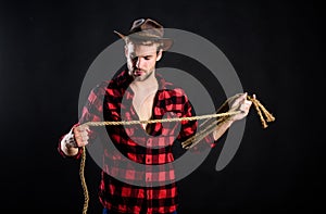 Lasso is used in rodeos as part of competitive events. Lasso can be tied or wrapped. Western life. Man unshaven cowboy