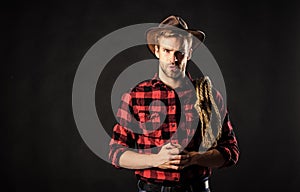 Lasso used rodeos competitive events. Lasso can be tied or wrapped. Brutal and confident. Western life. Man unshaven photo
