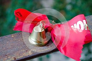 Last call. A bell with a red ribbon. Spring holiday. School years. Graduation. School bells on the background of green