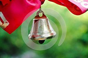 Last call. A bell with a red ribbon. Spring holiday. School years. Graduation. School bells on the background of green