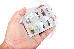 Last capsule medicine with drug panel in hand isolated on white background. Capsule medicine with packaged in palm isolated