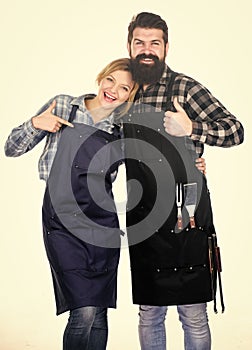 The last details. Family weekend. Couple in love hold kitchen utensils. Man bearded hipster and girl. Preparation and