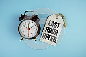 Last Hour Offer text on price tag with alarm clock on blue background