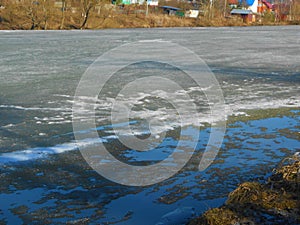 Last melting ice on the lake in springtime in sunny warm day.