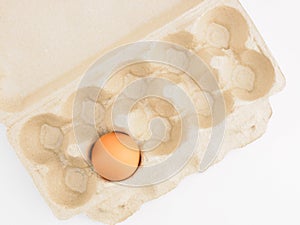 Last one raw chicken egg per pack on white background. Healthy eating concept