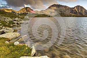 The last rays of the sun over Tevno Lake and Kamenitsa peak, Pirin Mountain