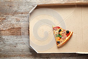 Last slice of tasty pizza in cardboard box