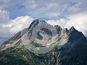 Last snow melting on an alpine mountain due to global warming