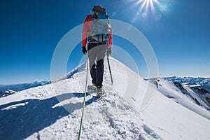 Last steps before Mont Blanc Monte Bianco summit 4,808 m of man with climbing axe dressed mountaineering clothes, boots with