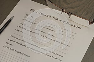 Last Will and Testament document with a pair of glasses and pen.