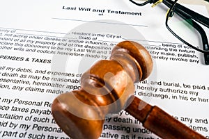 Last will and testament document with pen, glasses and gavel