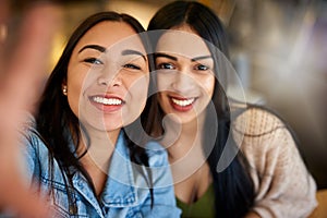 These are the lasting memories well look back on. Portrait of two young friends taking a selfie together.