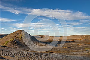 The late afternoon sun casts shadows across the sand dunes at Adolfo Lopez Mateos in Baja California photo