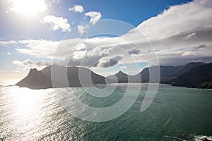 Late afternoon sun reflecting in ocean against beautiful mountain range at Houtbay