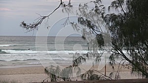 A late afternoon surfer still trying to catch waves.