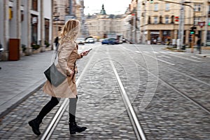 Late again to work. Panning shot of rushing woman running at street