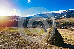 Ate autumn countryside landscape with farming haystacks in highland area of Carpathian Mountains