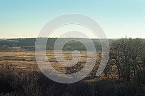 Late autumn landscape, wild nature in October November. fields forests and trees on a clear day