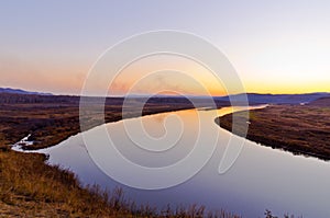 Late autumn sunset grassland near the river