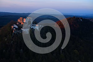 Late evening, artisitic, aerial view of monumental Buchlov Castle, lit by setting sun. Czech republic.