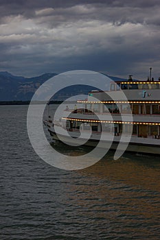 late evening passenger boat leaving harbour of city lindau