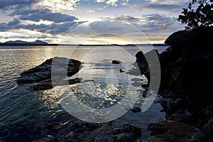 Late evening sun, clouds and reflections in ocean at northern tip of Thetis Island