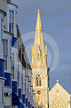 Late evening sun setting on the spire and steeple of church in W