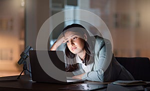 These late nights are a little too much. an attractive young businesswoman looking bored while working late at her