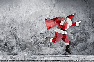 Late Santa claus in a hurry with traditional red white costume a