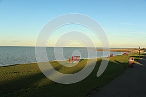 Late summer strolling over the sands on the beaches of Whitstable, Kent, UK taking in the sights and patterns in the sand made by