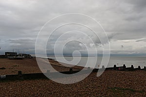 Late summer strolling over the sands on the beaches of Whitstable, Kent, UK taking in the sights and patterns in the sand made by