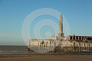 Late summer strolling over the sands on the beaches of Whitstable, Kent, UK taking in the sights and patterns in the sand made by