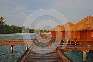 Late Sunrise with sunlight falling all over the overwater villa at a tropical resort island, Maldives