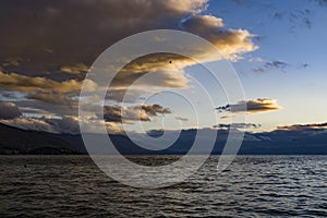 Late sunset at Ohrid lake with dramatic yellow and blue sky