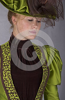 Late Victorian woman in green silk ensemble