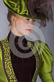 Late Victorian woman in green silk ensemble