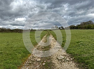 Late winter rural scene, with a long gravel path, stretching to the horizon in, Bradley, Yorkshire, UK
