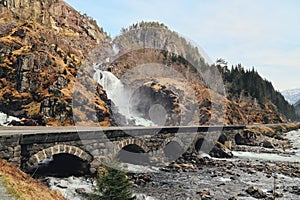 Latefossen Waterfall Odda Norway with the stone road bridge across in spring April season.