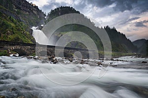 Latefossen waterfall with stone bridge near Odda, Norway