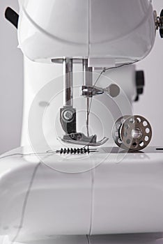 Lateral detail sewing machine needle and thread spool